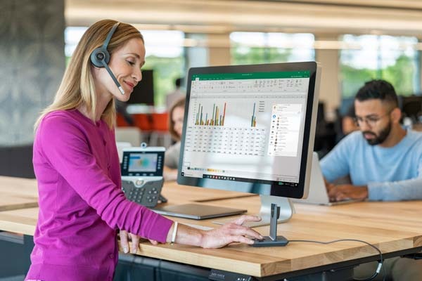 Woman at desk wearing headset