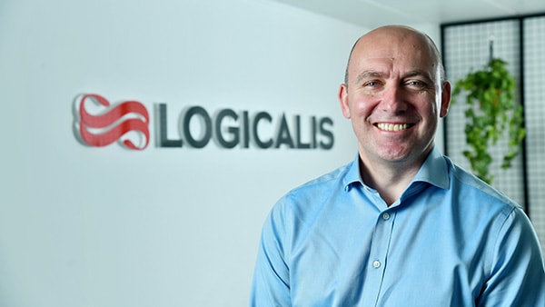 Bob Bailkoski smiling with Logicalis’ logo in the background