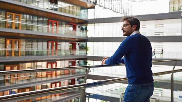 Person looking out over balcony