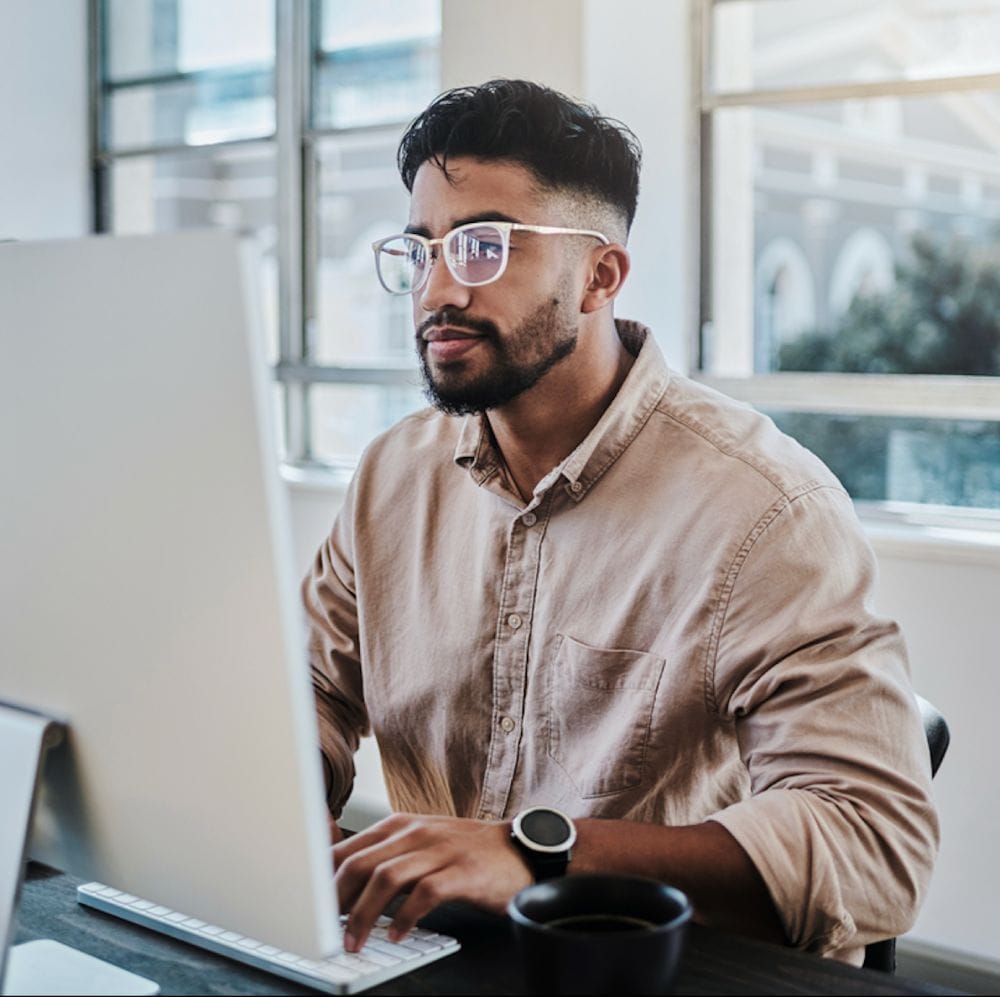 Information technology businessman working on computer in office for digital app, software development or website ux ui design. Young graphic designer with coding project or online company management