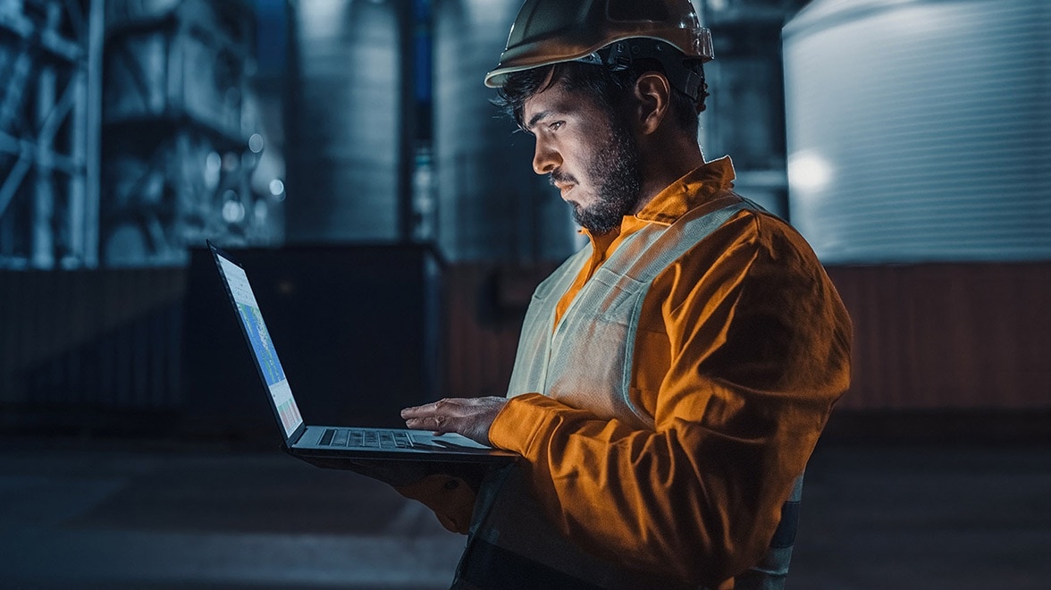 Industrial dressed man working on rugged laptop