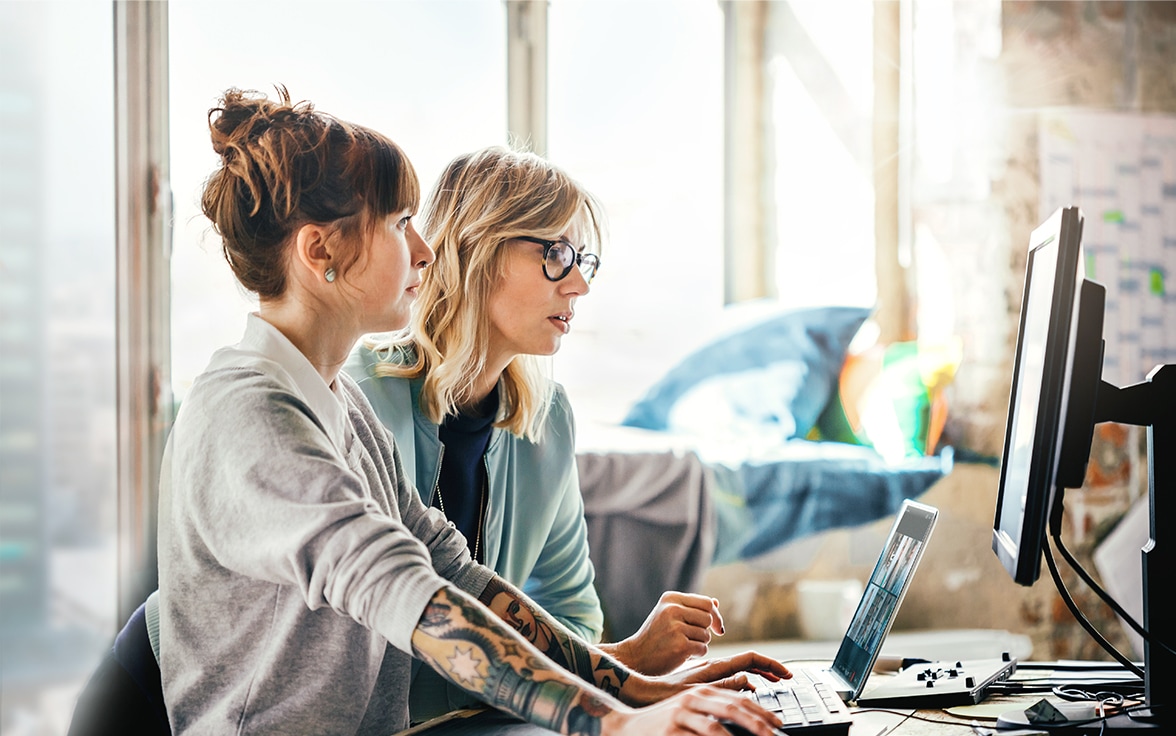 Two people collaborating while viewing computer screen