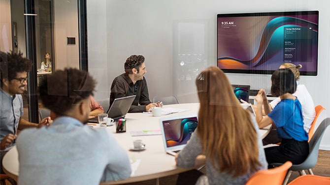 Hybrid workers meeting in a Cisco-enabled collaboration room