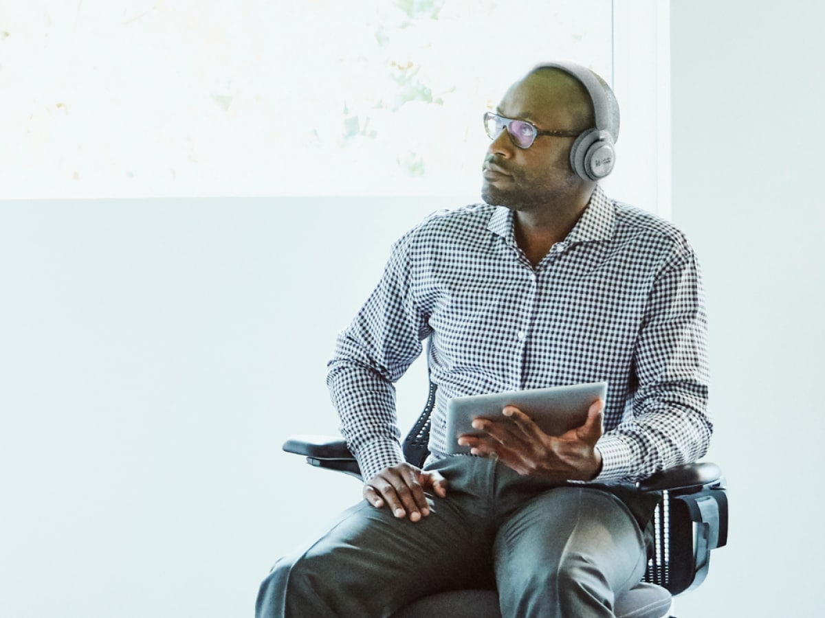 Person wearing a Webex by Cisco headset and in a Webex meeting on a mobile phone 