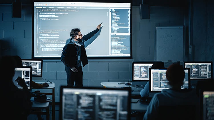 Instructor teaching programming in computer lab classroom