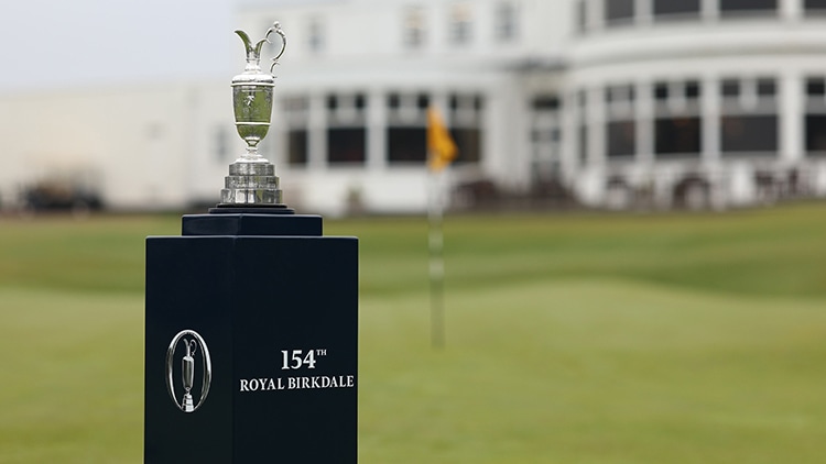 The Claret Jug trophy sits atop a black display pedestal
