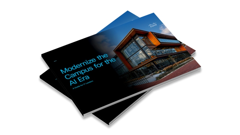 Two employes working at a desk on computers