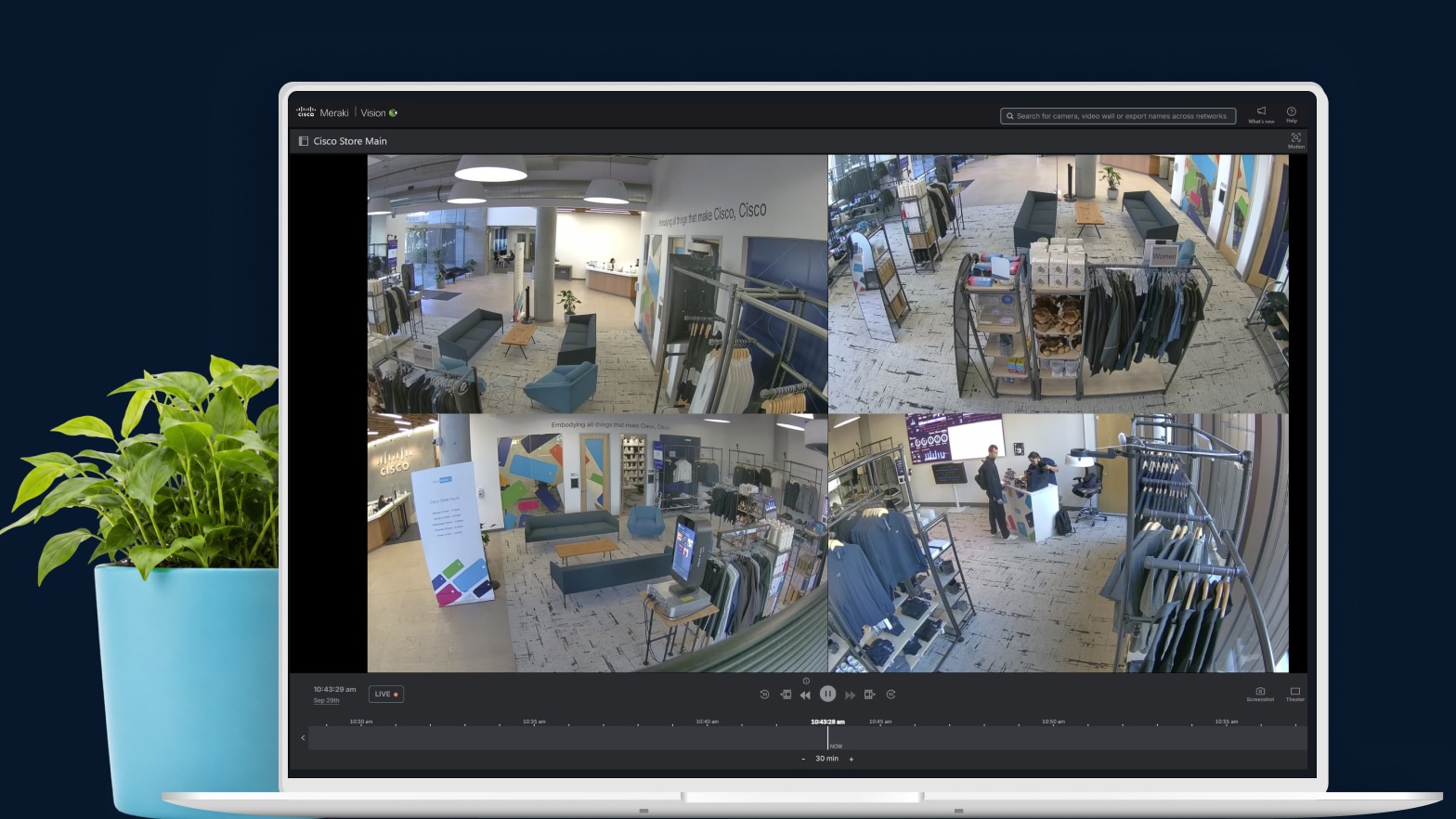 Cisco Meraki dashboard on a computer monitor showing four security camera feeds from a retail store.